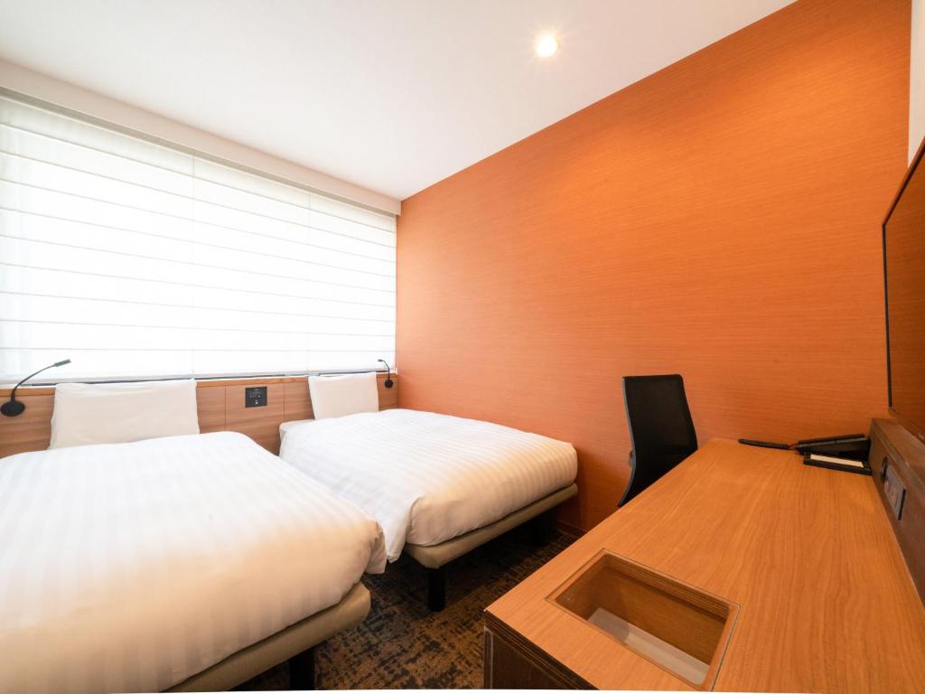 Postel nebo postele na pokoji v ubytování Comfort Inn Fukuoka Tenjin
