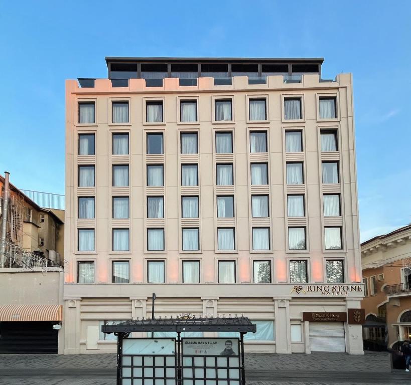a large tan building with a sign on it at Ring Stone Hotels Bosphorus - Special Class in Istanbul