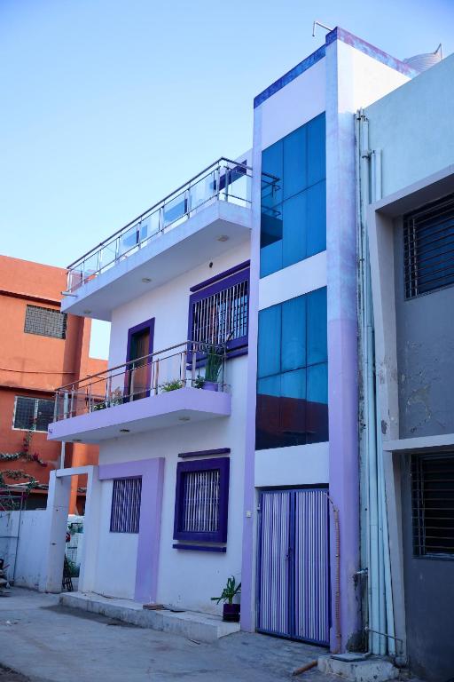 un edificio blanco con un balcón en el lateral. en Samyak bunglow, en Dwarka