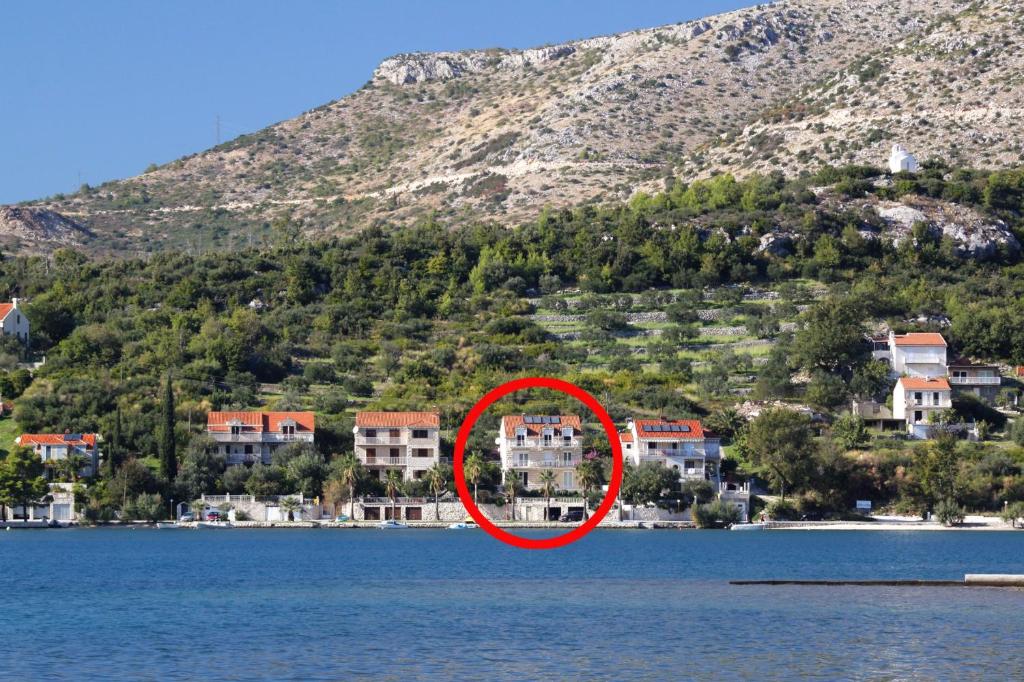 a house in the middle of a body of water at Apartments by the sea Slano, Dubrovnik - 8538 in Slano