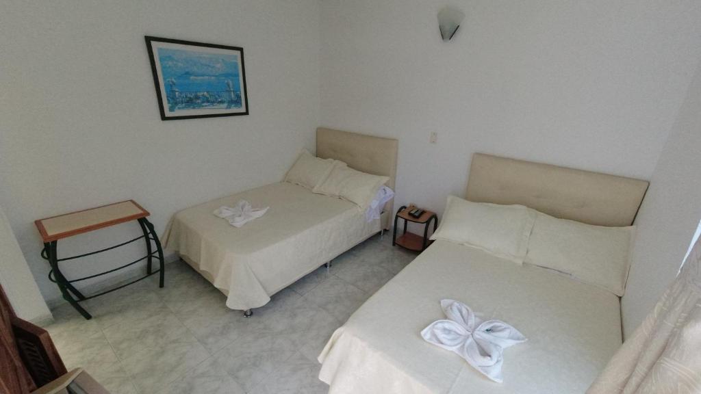 Postel nebo postele na pokoji v ubytování Hotel Miami en Melgar