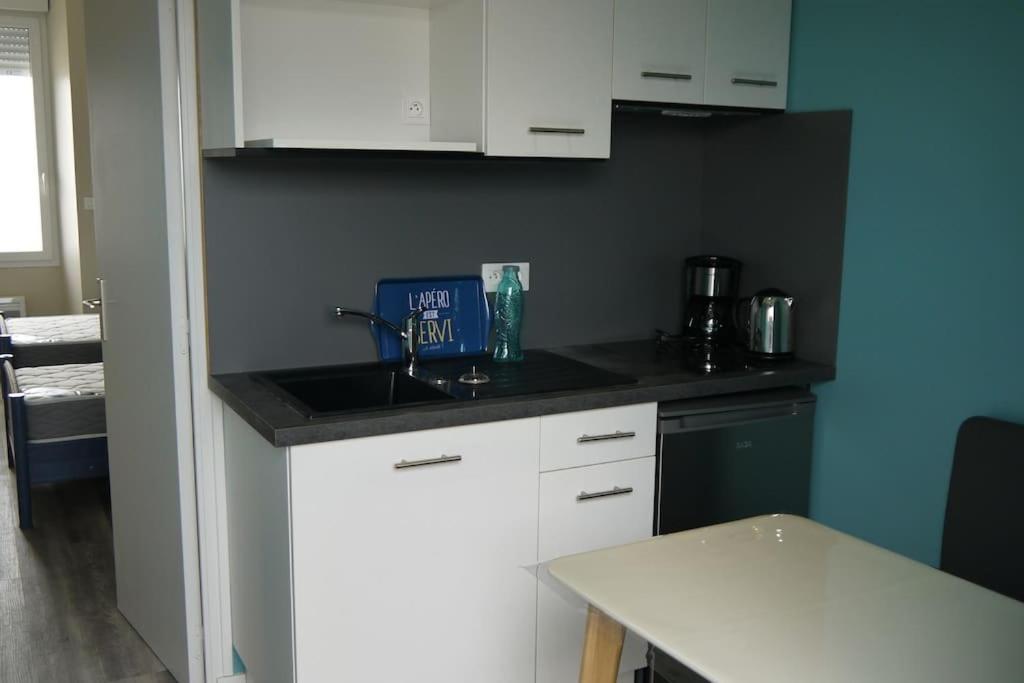 a kitchen with a sink and a counter top at Appart : houedic : plein sud, front de mer in La Bernerie-en-Retz