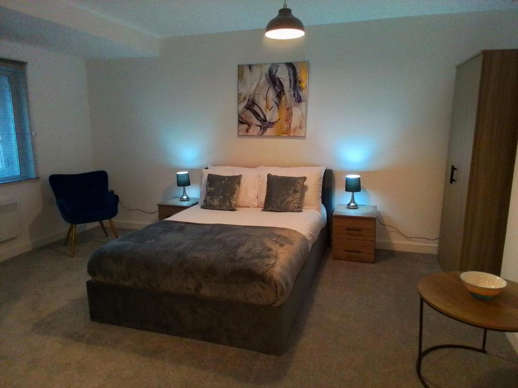 a bedroom with a bed and two tables and a chair at 14 Plants Yard in Worksop