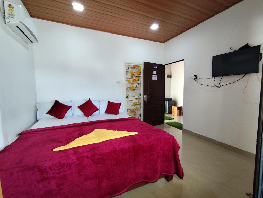 a bedroom with a bed with a yellow robe on it at Noel's beach homestay in Alleppey