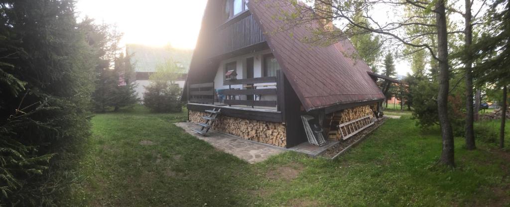 une maison avec un toit en gambrel sur son côté dans l'établissement Chata Loučná pod Klínovcem, à Loučná pod Klínovcem