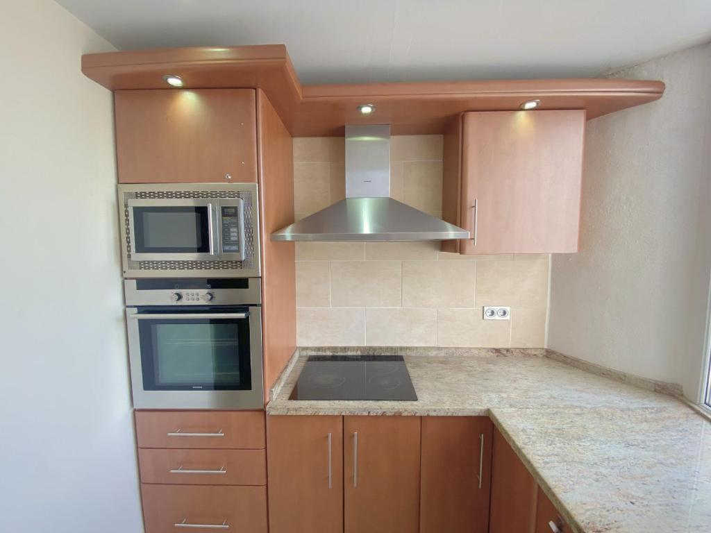 A kitchen or kitchenette at Benalmadena Harbour Penthouse with big terrace and sea view