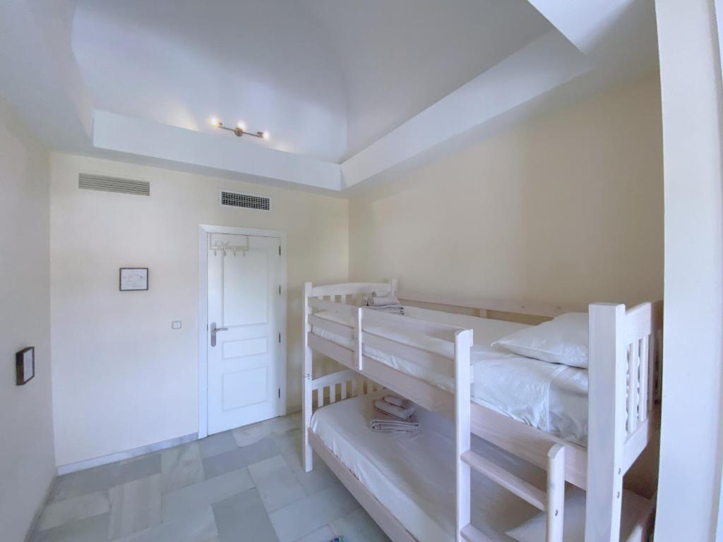 A bed or beds in a room at Benalmadena Harbour Penthouse with big terrace and sea view