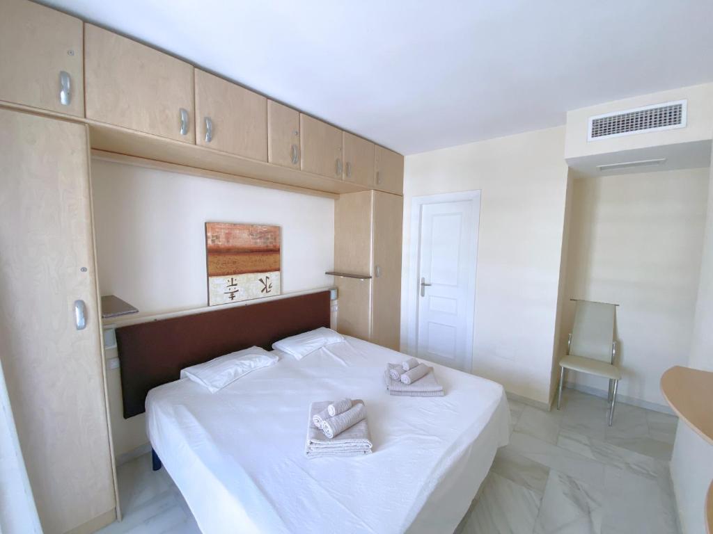 A bed or beds in a room at Benalmadena Harbour Penthouse with big terrace and sea view