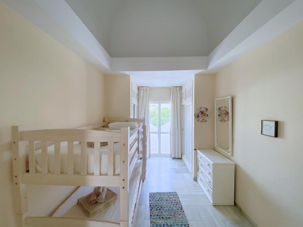 A bed or beds in a room at Benalmadena Harbour Penthouse with big terrace and sea view