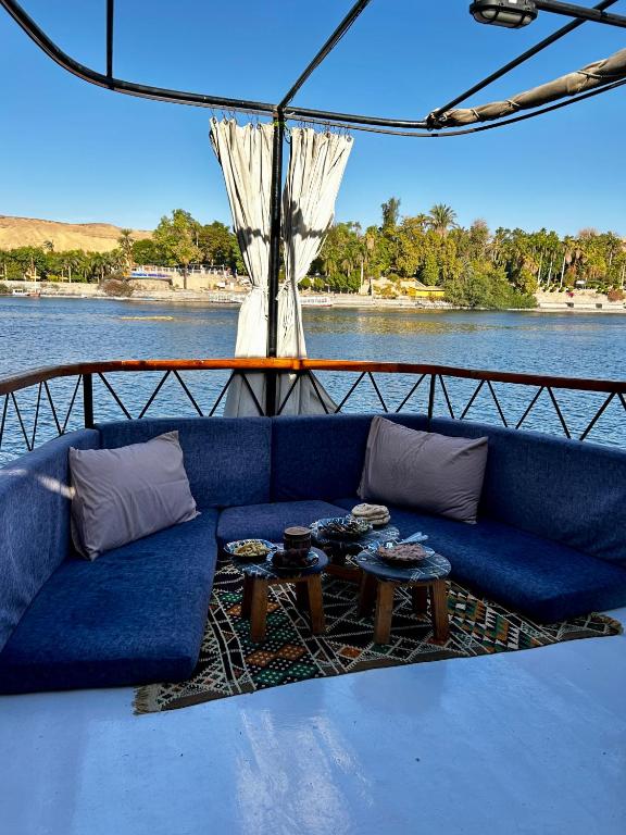 a blue couch sitting on the back of a boat at Houseboat Hotel and Nile Cruises Zainoba in Nag` el-Ramla