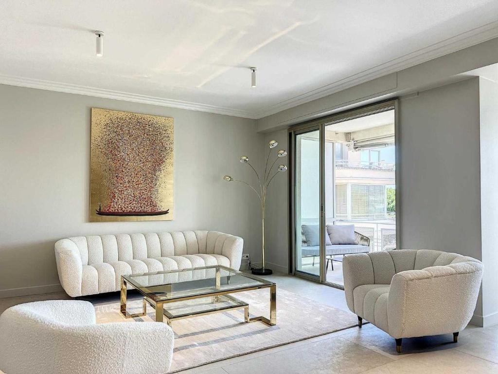 un salon avec un canapé, une table et des chaises dans l'établissement Luxurious Apartment Sea View Terrace La Croisette, à Cannes