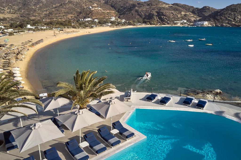 an aerial view of a beach with chairs and a swimming pool at Ios Palace Hotel & Spa in Mylopotas