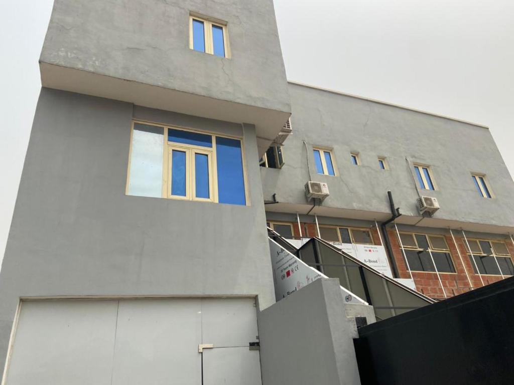 a building with blue windows on the side of it at Hope Residence Hotel and suite in Lagos