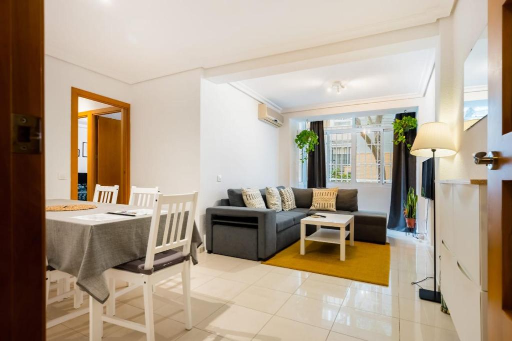 a living room with a couch and a table at San Pagés 3BR Apartment in Seville