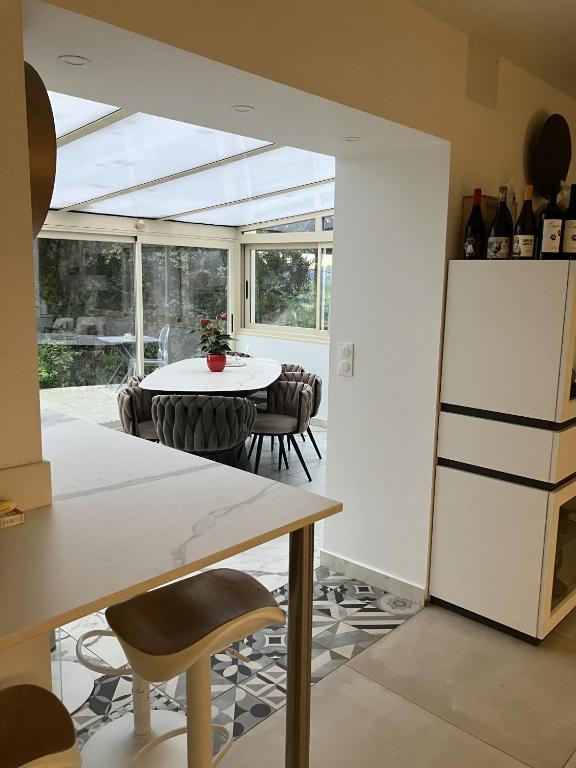 a kitchen with a table and a refrigerator at villa vue mer cinq chambres Les terrasses des Collines in Le Cannet