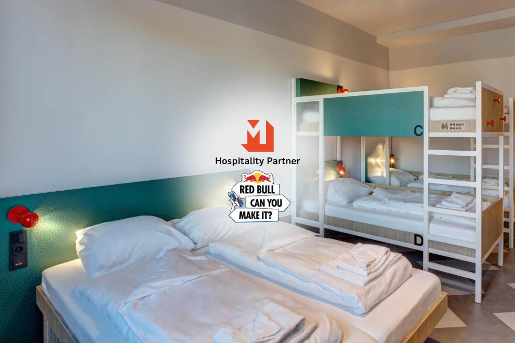 two bunk beds in a room with a sign on it at MEININGER Hotel Paris Porte de Vincennes in Paris