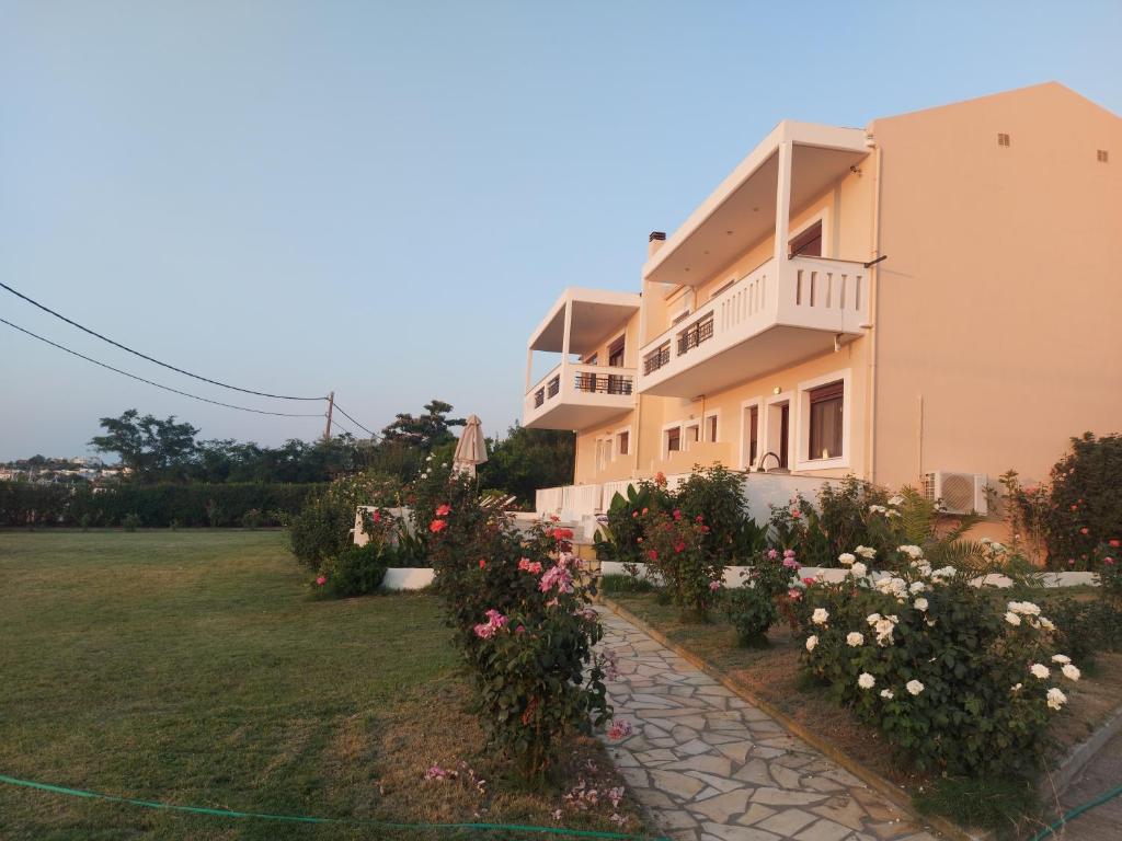 a house with flowers in front of it at Aktaion Apartments in Samothráki