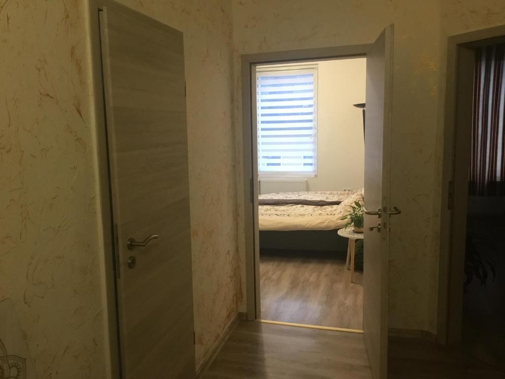 an open door leading to a bedroom with a bed at Angel in Altenburg