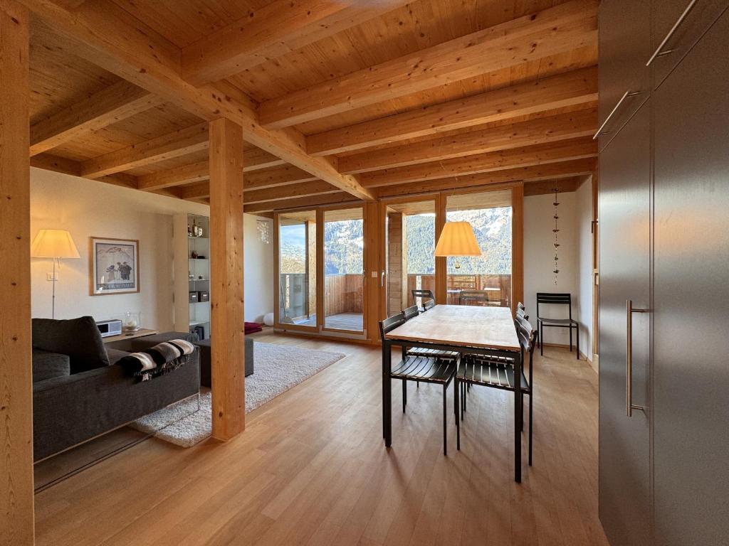 a living room with a table and a couch at Chalet Roossi 4 in Wengen