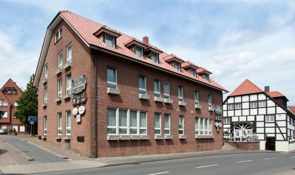 a red brick building on the side of a street at Hotel Hubertus in Ennigerloh