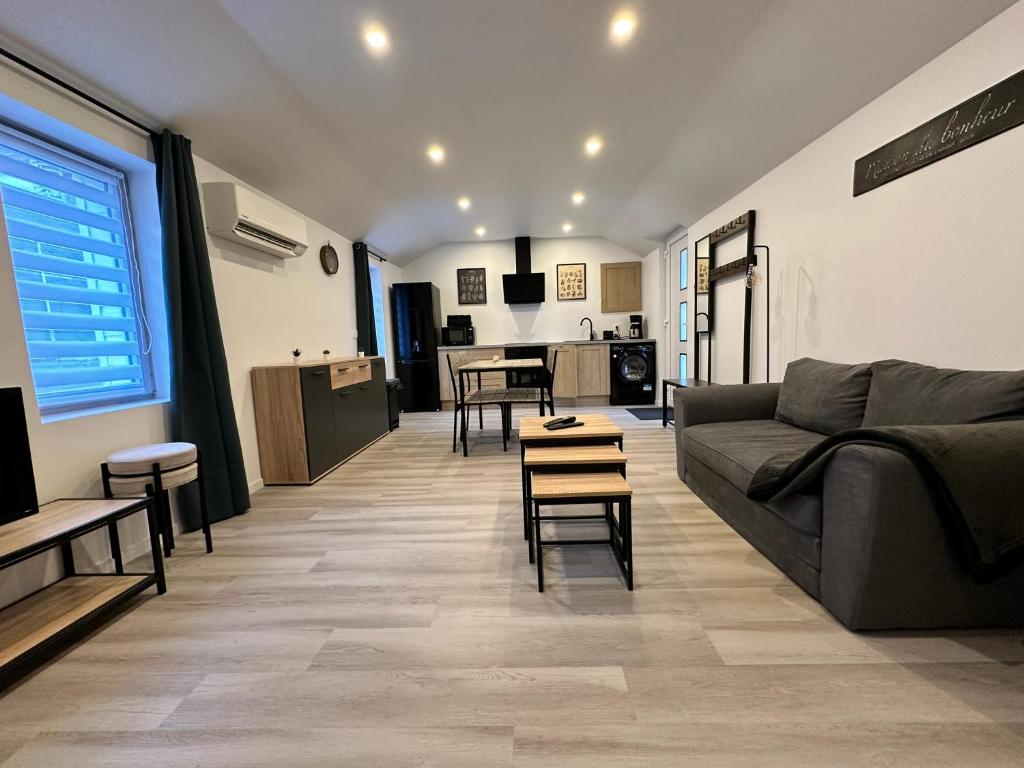 a living room with a couch and a table at Chez FanF & Nanie in Isigny-sur-Mer
