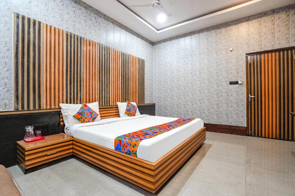 a bedroom with a large bed in a room at FabHotel Rahul Palace in Nagpur