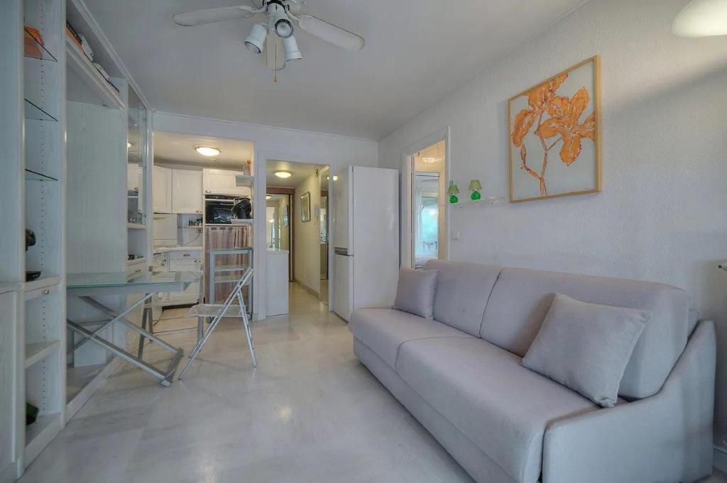 a living room with a couch and a kitchen at One Bed Apt in the center of Cannes - 2198 in Cannes