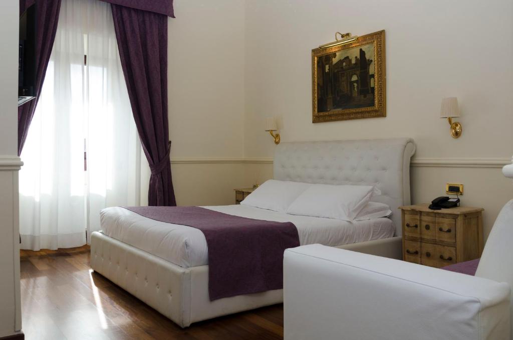 Postel nebo postele na pokoji v ubytování Hotel Traiano
