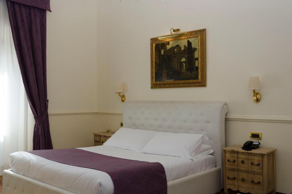 Postel nebo postele na pokoji v ubytování Hotel Traiano