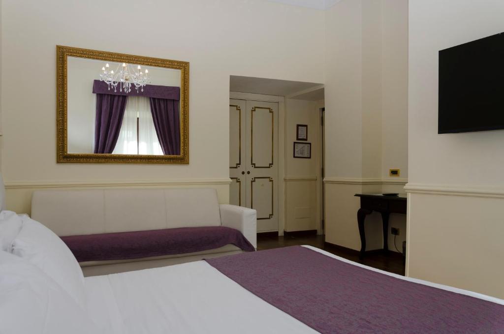 Postel nebo postele na pokoji v ubytování Hotel Traiano