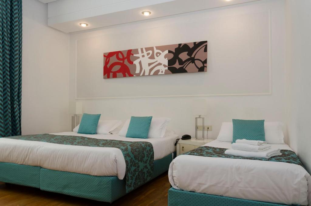 Postel nebo postele na pokoji v ubytování Hotel Traiano