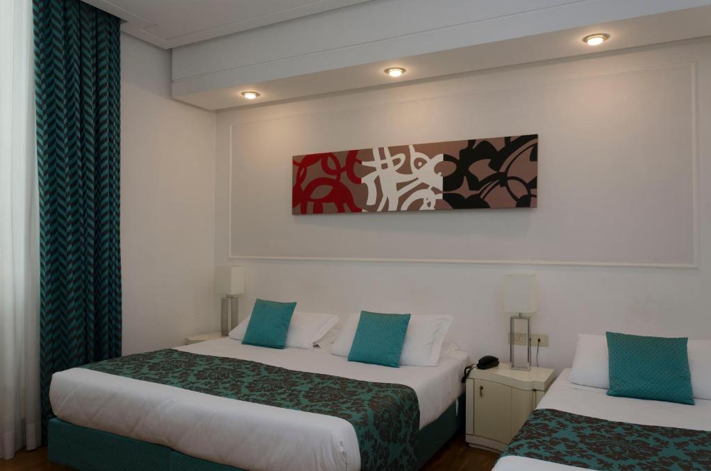 Postel nebo postele na pokoji v ubytování Hotel Traiano