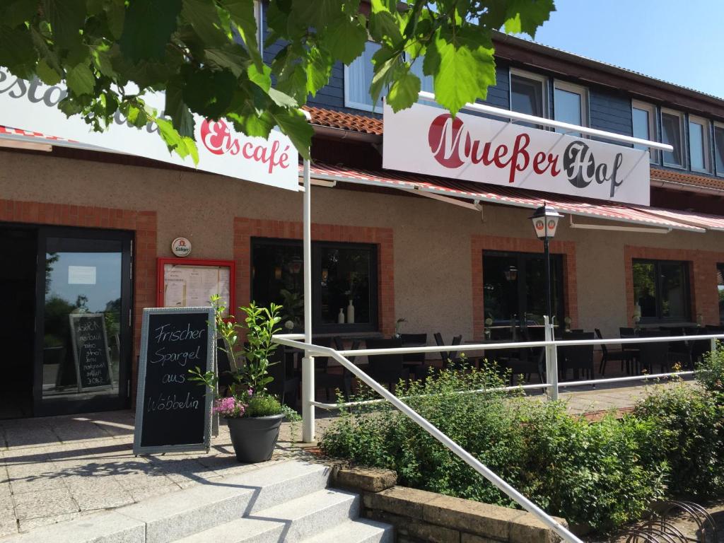 a burger shop with a sign in front of it at Mueßer Hof in Schwerin