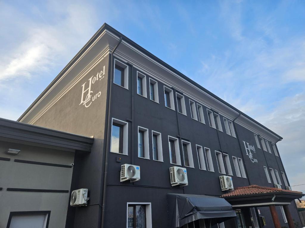 a black building with writing on the side of it at Hotel Euro in Castegnato