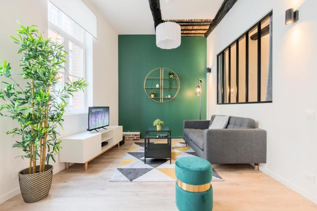 a living room with green walls and a couch at Character apartment in the heart of Old Lille in Lille