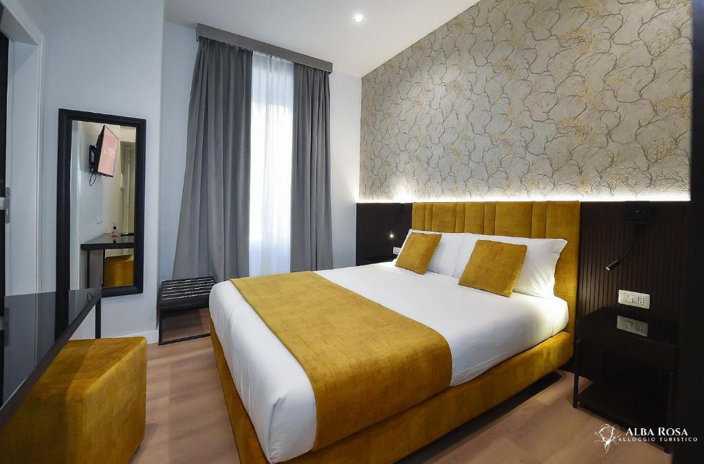 a bedroom with a large bed in a room at Alba Rosa Rooms in Rome
