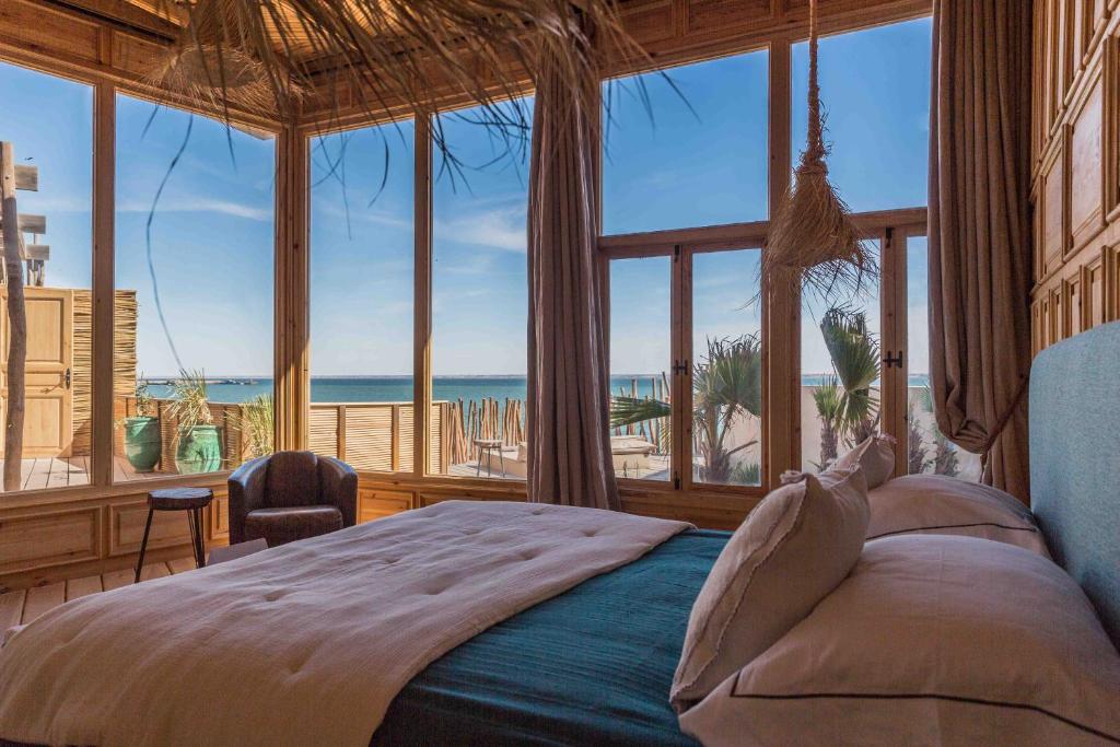 a bedroom with a bed with a view of the ocean at Palais Rhoul & Spa Dakhla in Dakhla