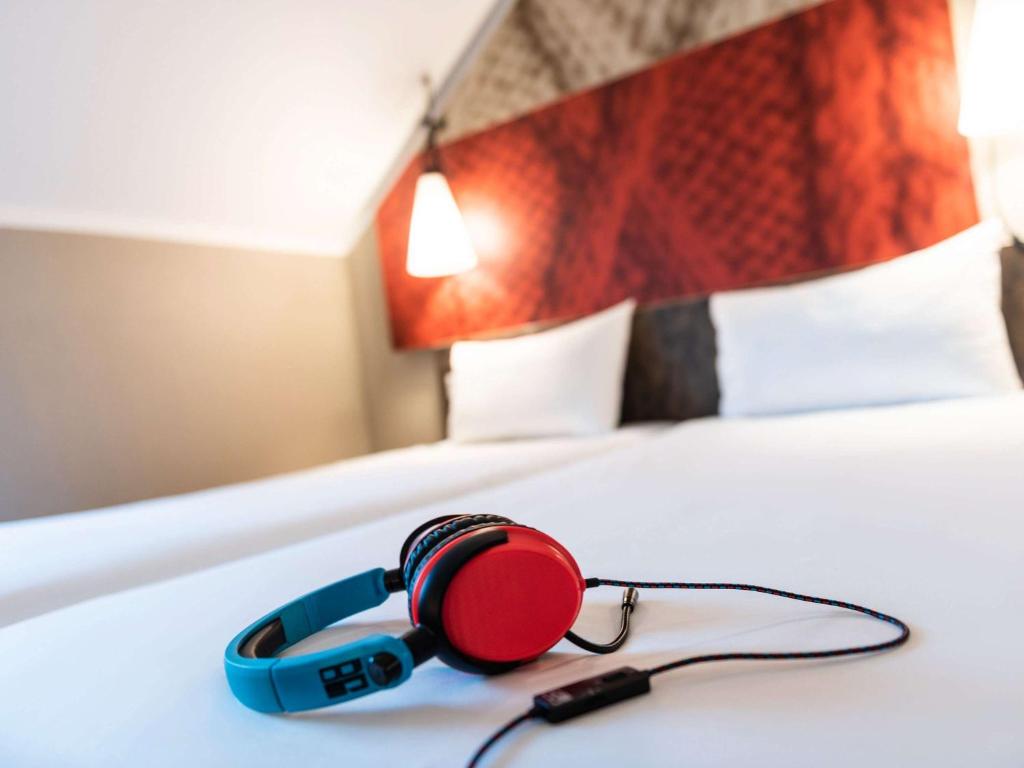 Postel nebo postele na pokoji v ubytování ibis Hotel Regensburg City