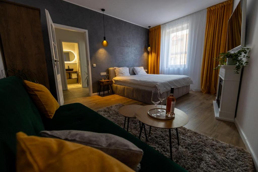 a hotel room with a bed and a couch at Cozy Studio in Sibiu