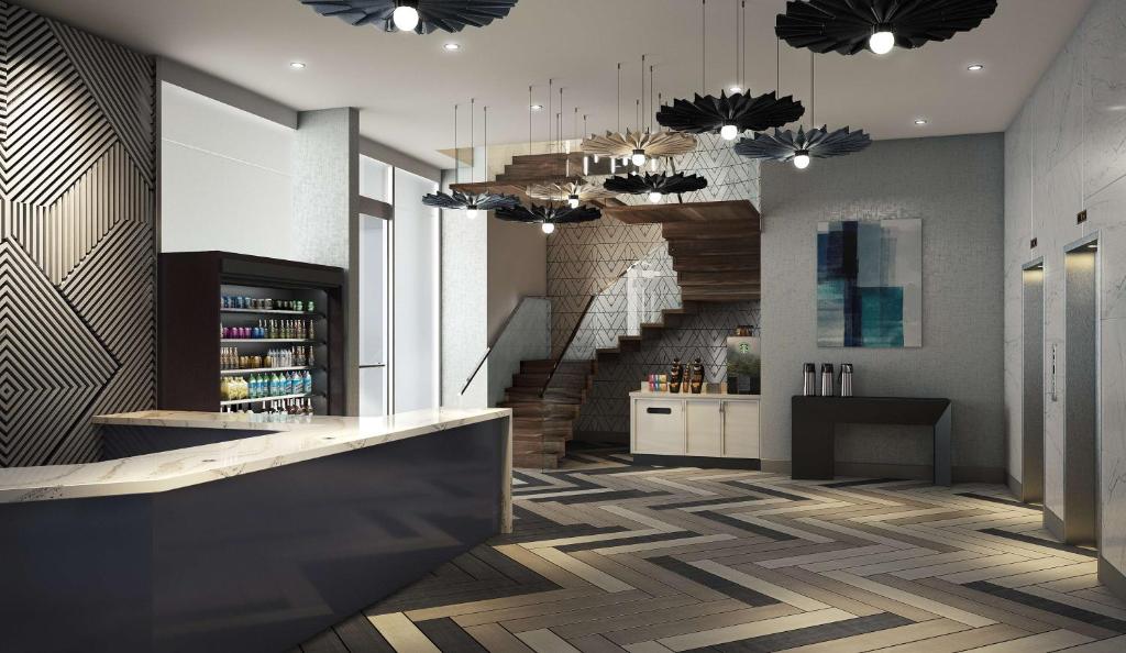 a lobby with a spiral staircase and a stair case at Hyatt Place NYC Chelsea in New York