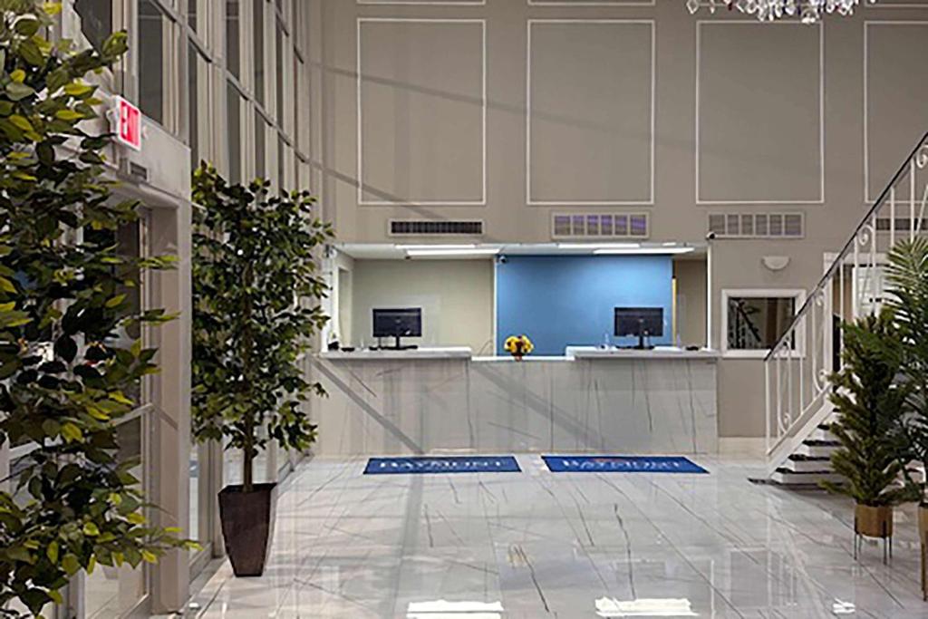 an empty lobby of an office building with plants at Baymont by Wyndham Deming in Deming