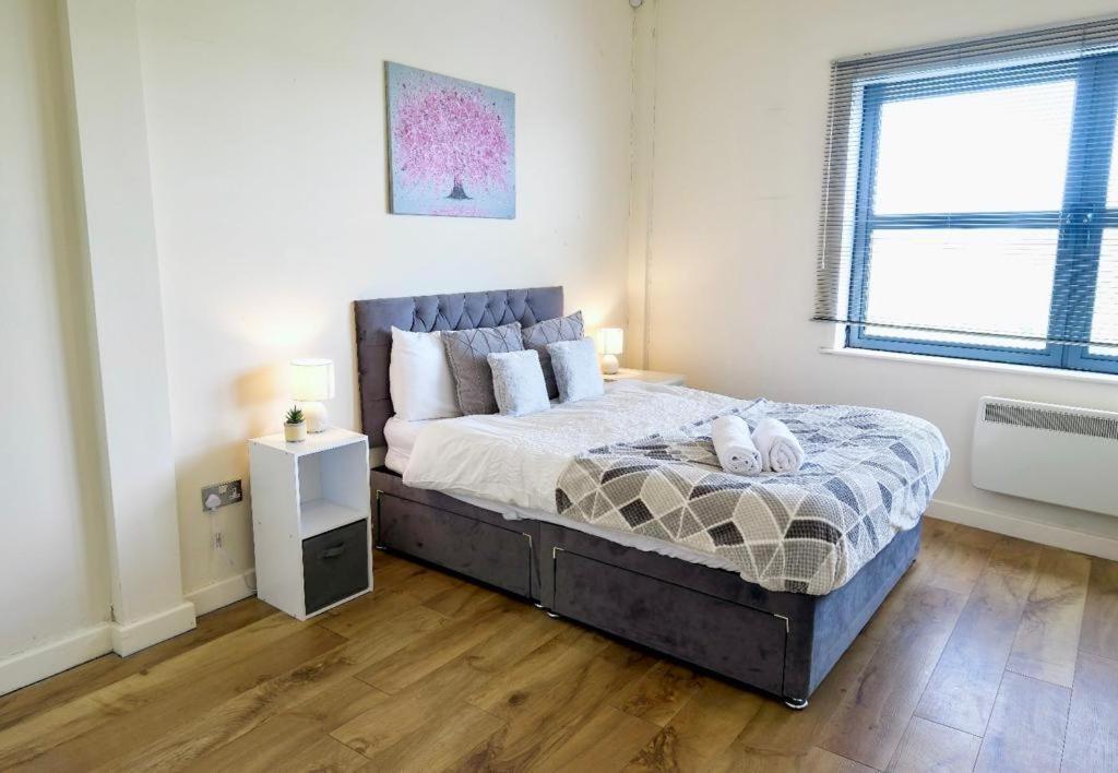 a bedroom with a bed and a window at Peaceful Coventry Retreat - Free parking in Coventry