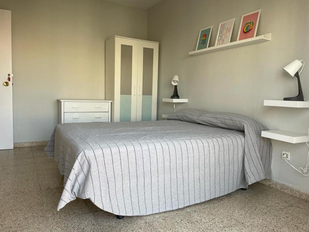 a bedroom with a bed with a striped bedspread at Bahia de Algeciras in Algeciras
