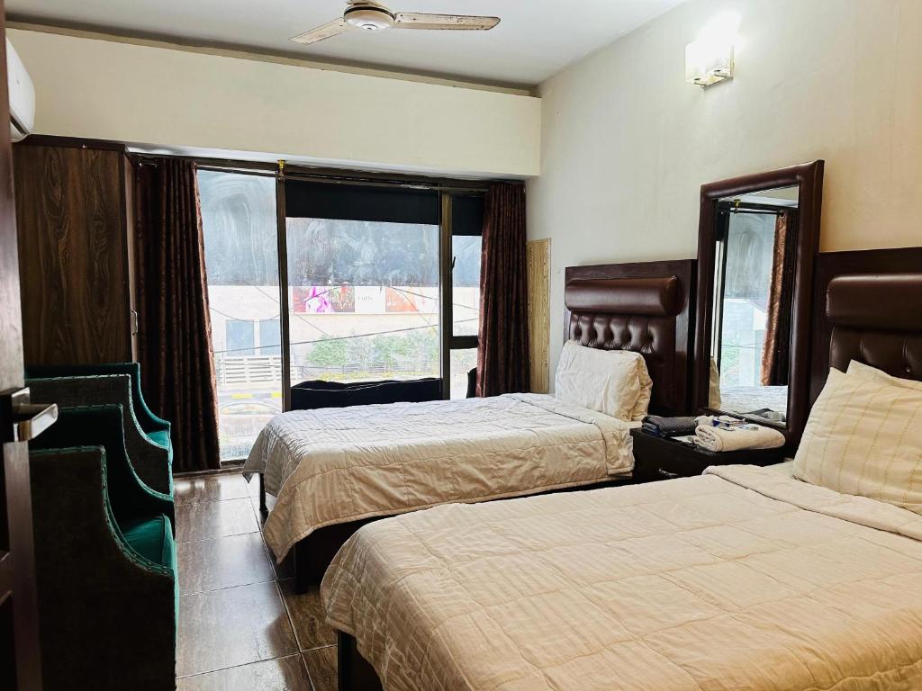 Postel nebo postele na pokoji v ubytování Hotel SeaView 2