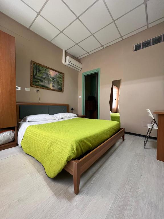 トリノにあるAlloggio Lanciaのベッドルーム1室(大型ベッド1台、緑の毛布付)