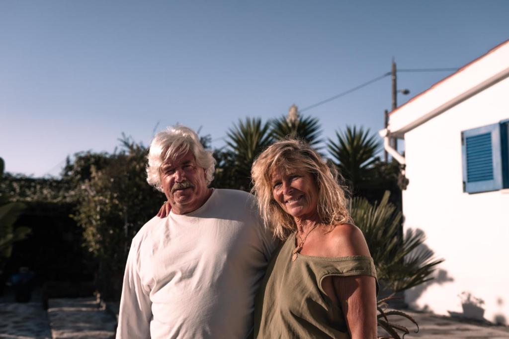 a man and a woman standing in front of a house at João Jungle in Açafora