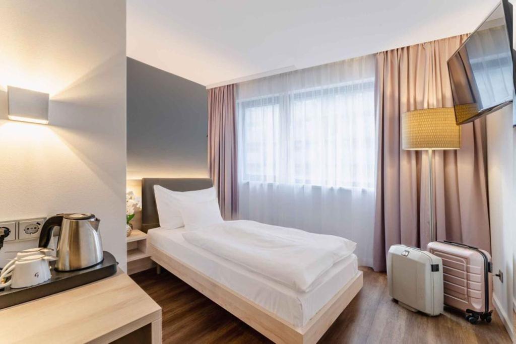 Postel nebo postele na pokoji v ubytování PLAZA INN Wien Gasometer