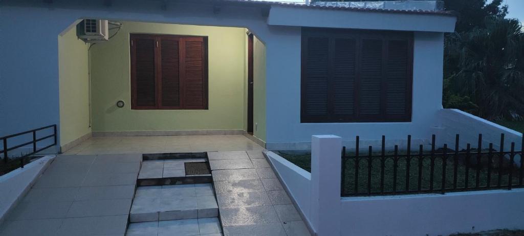 a house with a black fence and a door at Departamento Bienestar Termas in Federación