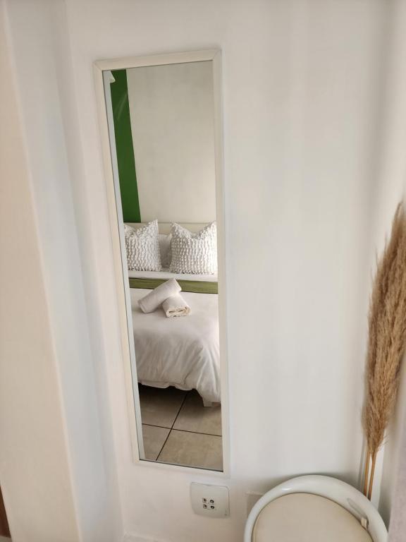 a mirror in a room with a bed in a room at 297 The Blyde Crystal Lagoon in Pretoria