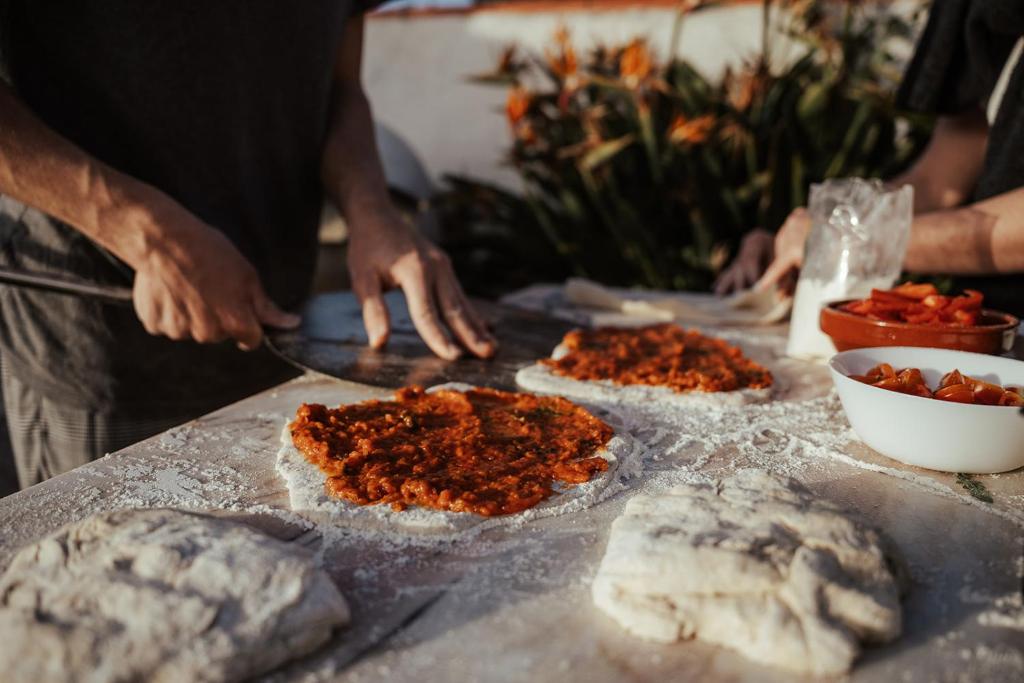 a group of people preparing food on a table at João Jungle in Açafora